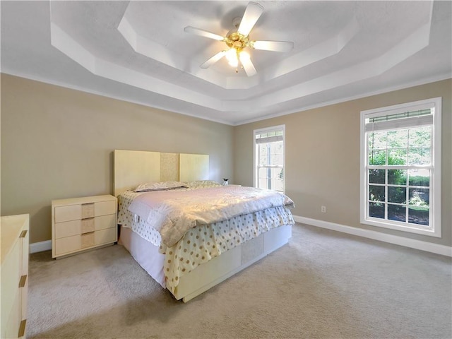 1012 Gloria Grand Blvd, Mcdonough, GA 30252 - bedroom with a tray ceiling, light colored carpet, baseboards, and a ceiling fan