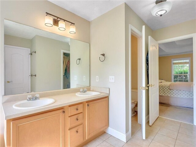 1012 Gloria Grand Blvd, Mcdonough, GA 30252 - bathroom with ensuite bathroom, tile patterned floors, toilet, double vanity, and a closet