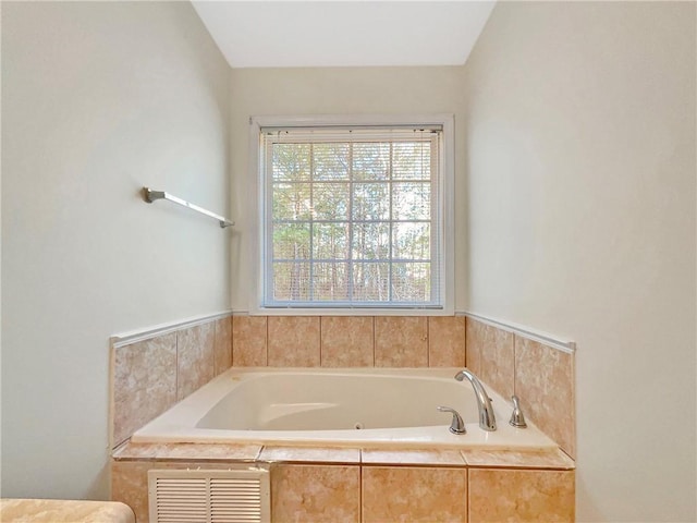 bathroom featuring visible vents and a whirlpool tub