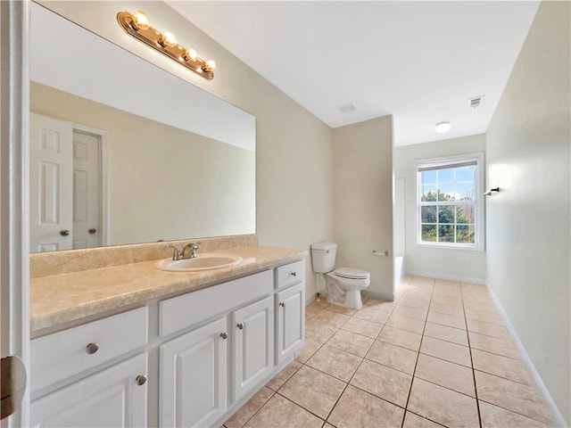 full bath featuring vanity, visible vents, baseboards, tile patterned flooring, and toilet