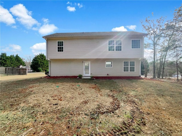 rear view of house with a yard