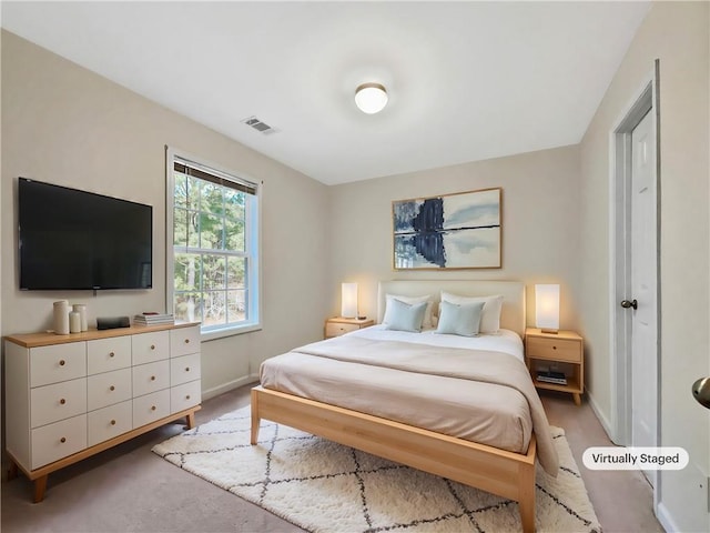 bedroom featuring visible vents and baseboards