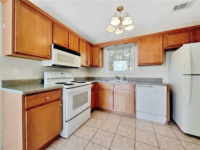 kitchen with visible vents, brown cabinets, a sink, white appliances, and light tile patterned floors