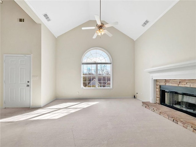 unfurnished living room with a stone fireplace, visible vents, carpet floors, and high vaulted ceiling