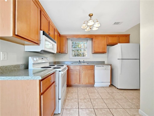 kitchen with white appliances, light tile patterned floors, visible vents, a sink, and a chandelier