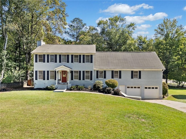 colonial home with a garage and a front yard