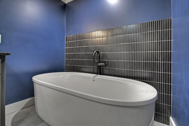 bathroom featuring tile patterned flooring, a bath, and vanity