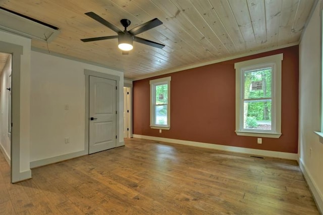 unfurnished room with crown molding, wood ceiling, ceiling fan, and light wood-type flooring