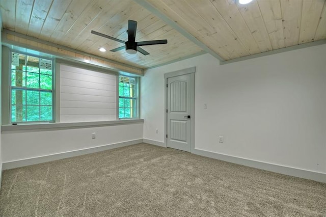 carpeted spare room featuring wooden ceiling and ceiling fan