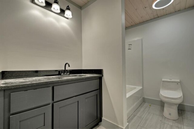 bathroom featuring a tub to relax in, vanity, toilet, and wooden ceiling