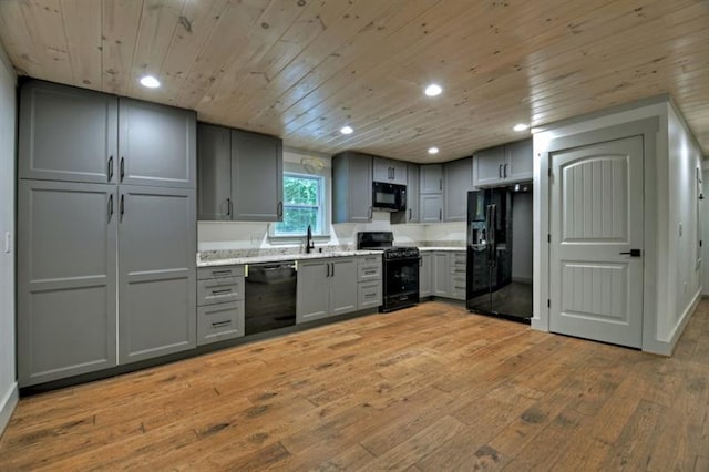 kitchen with sink, wood ceiling, gray cabinets, light hardwood / wood-style floors, and black appliances