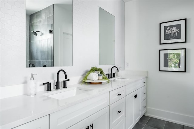 bathroom with tiled shower, vanity, and tile patterned floors