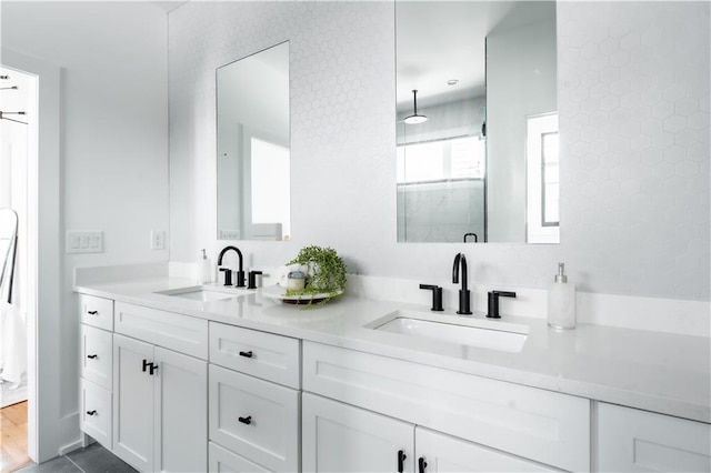 bathroom with hardwood / wood-style floors, walk in shower, and vanity