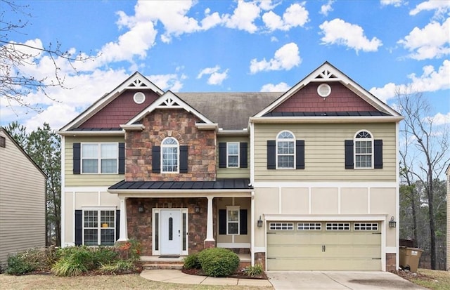 view of front facade featuring an attached garage, a standing seam roof, metal roof, stone siding, and driveway