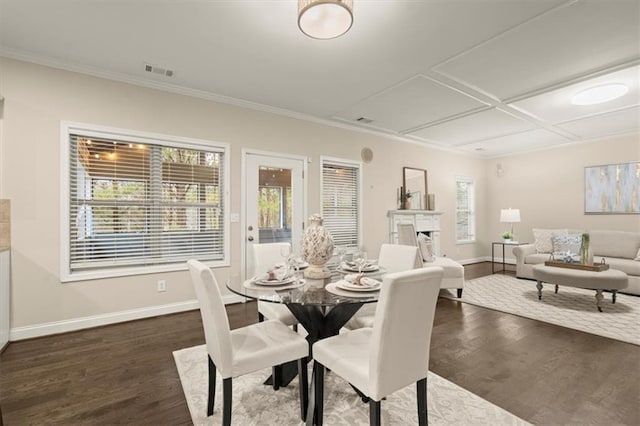 dining room with a wealth of natural light, a fireplace, visible vents, and baseboards