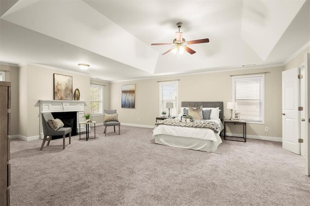 bedroom featuring ornamental molding, light carpet, and a fireplace