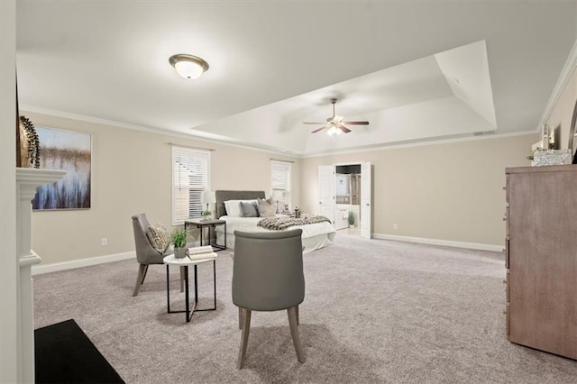 living area featuring light carpet, a tray ceiling, crown molding, and baseboards