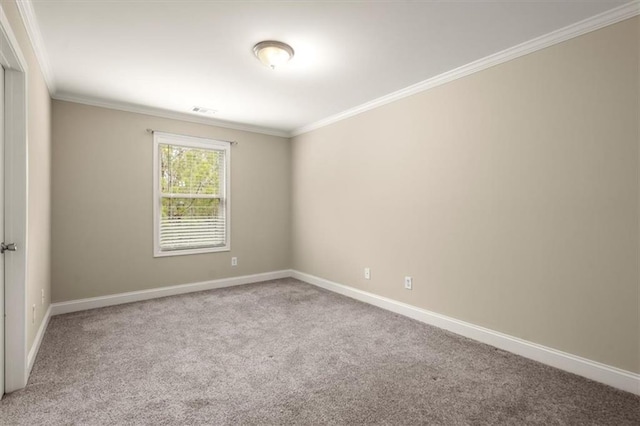 carpeted spare room featuring baseboards, visible vents, and ornamental molding