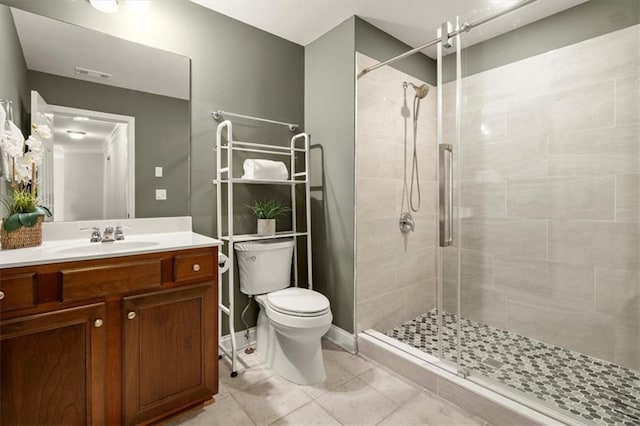 full bath with a stall shower, visible vents, toilet, tile patterned floors, and vanity