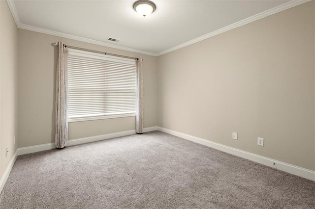 carpeted spare room with baseboards, visible vents, and crown molding