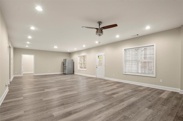 unfurnished living room with wood finished floors and recessed lighting