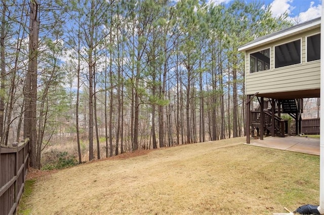 view of yard featuring stairs, a carport, a patio, and driveway