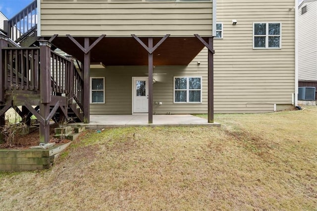 exterior space featuring a patio area, stairway, central AC unit, and a yard