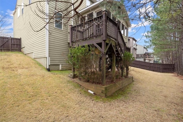 back of house featuring fence and a lawn