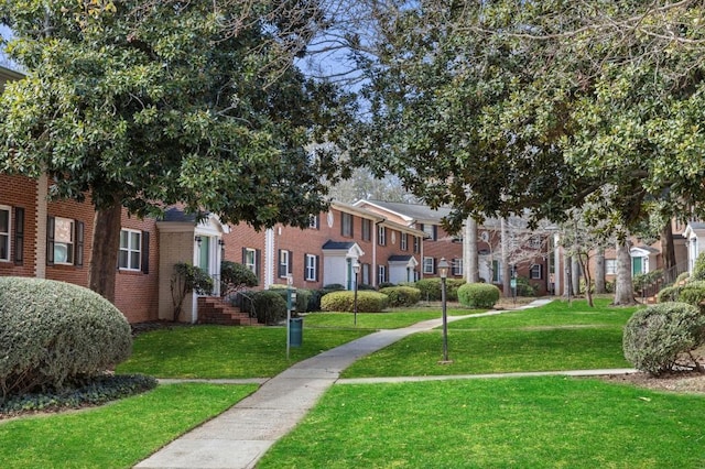 view of home's community with a yard