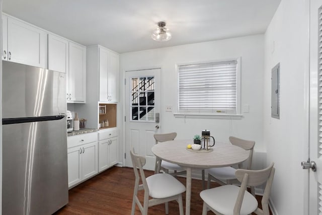 dining space with electric panel and dark hardwood / wood-style floors