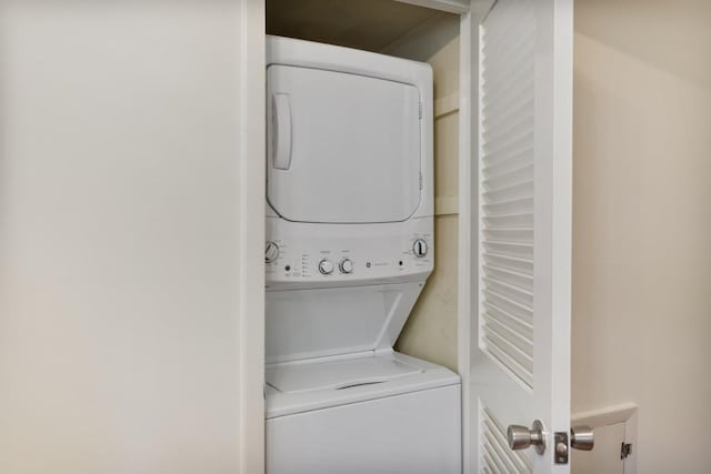 clothes washing area with stacked washer and dryer