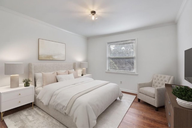 bedroom with ornamental molding and dark hardwood / wood-style floors