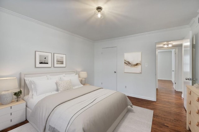 bedroom featuring ornamental molding and dark hardwood / wood-style flooring