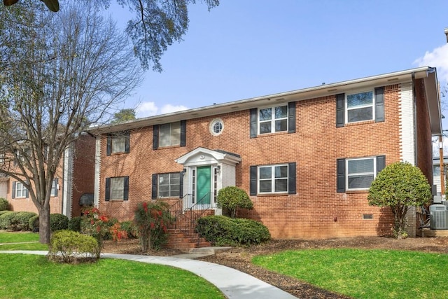 view of front of property featuring a front yard and central air condition unit