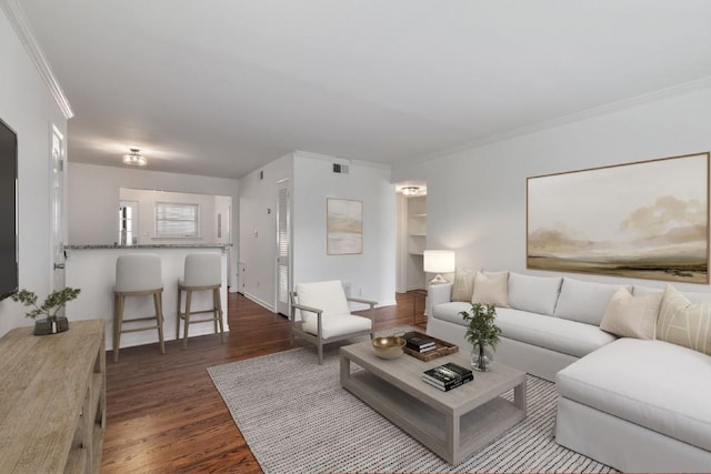 living room with crown molding and dark hardwood / wood-style floors