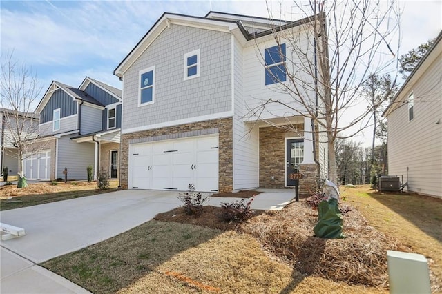 view of front of house featuring a garage and central AC