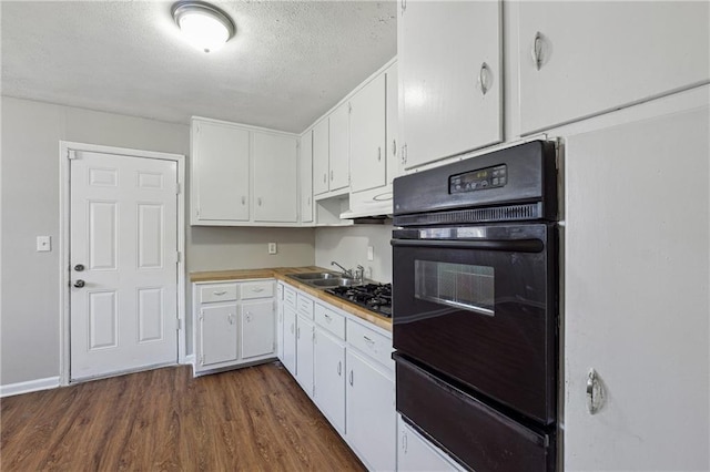 kitchen with dark hardwood / wood-style floors, sink, white cabinetry, a textured ceiling, and black oven