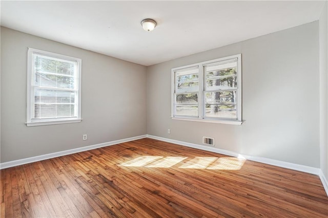 unfurnished room with wood-type flooring