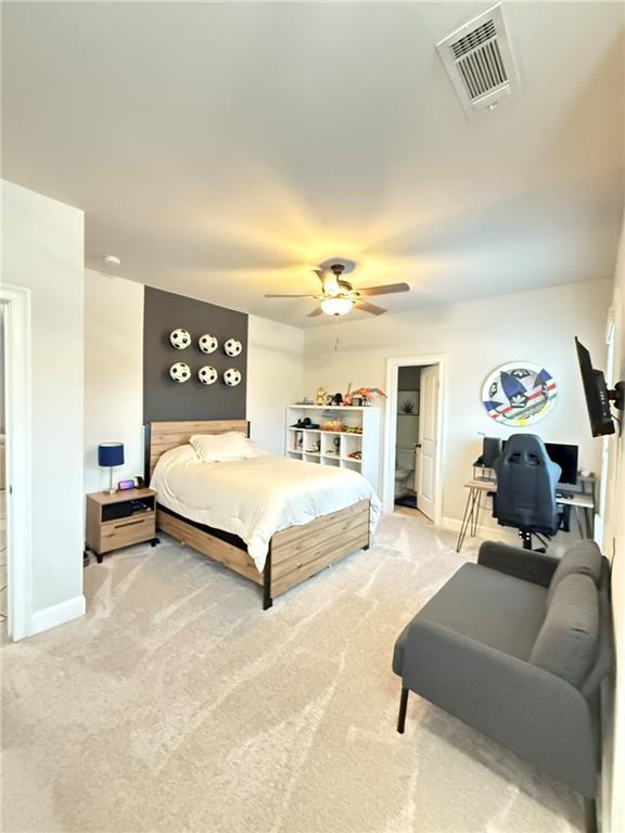 bedroom with light colored carpet and ceiling fan