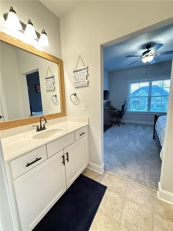 bathroom featuring vanity, tile patterned flooring, and ceiling fan