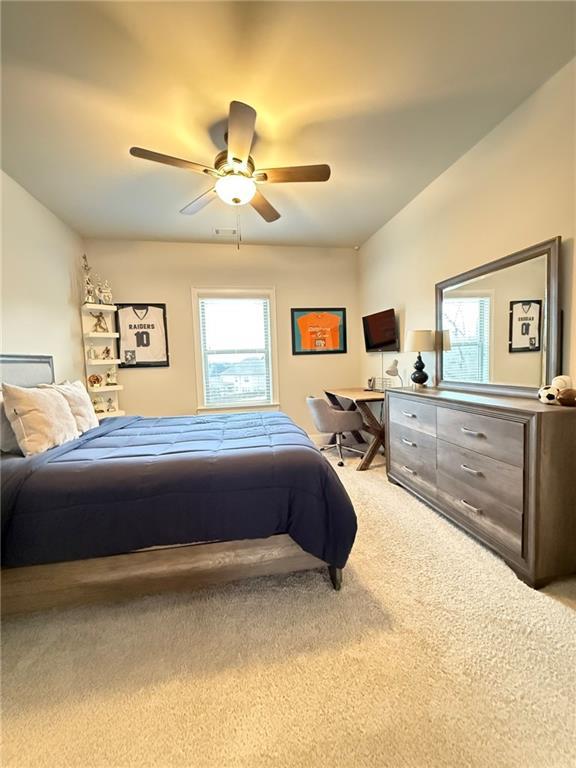 carpeted bedroom featuring ceiling fan