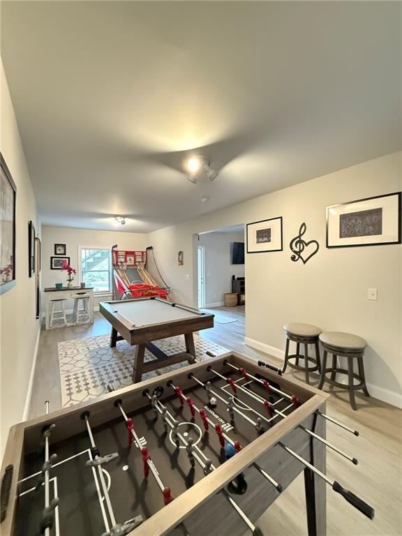 playroom with hardwood / wood-style flooring and billiards