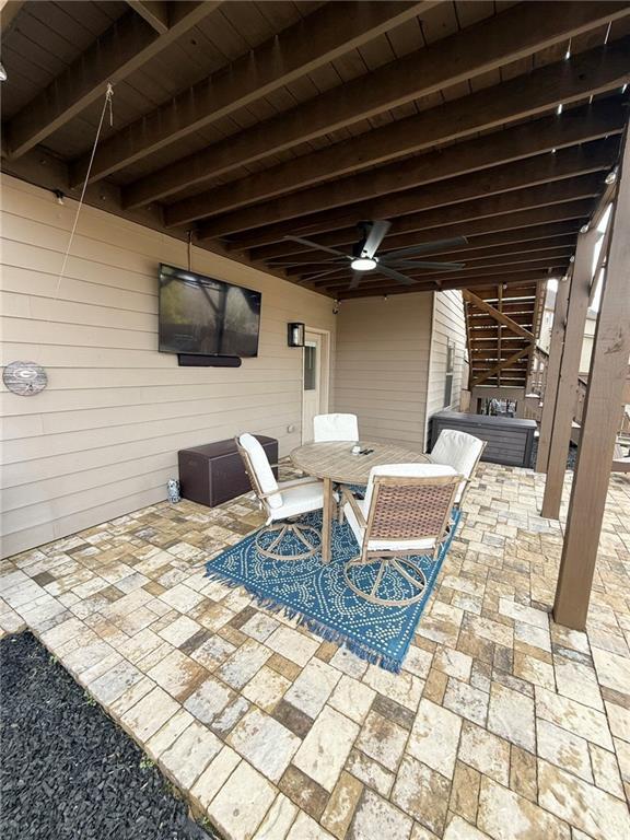 view of patio featuring ceiling fan