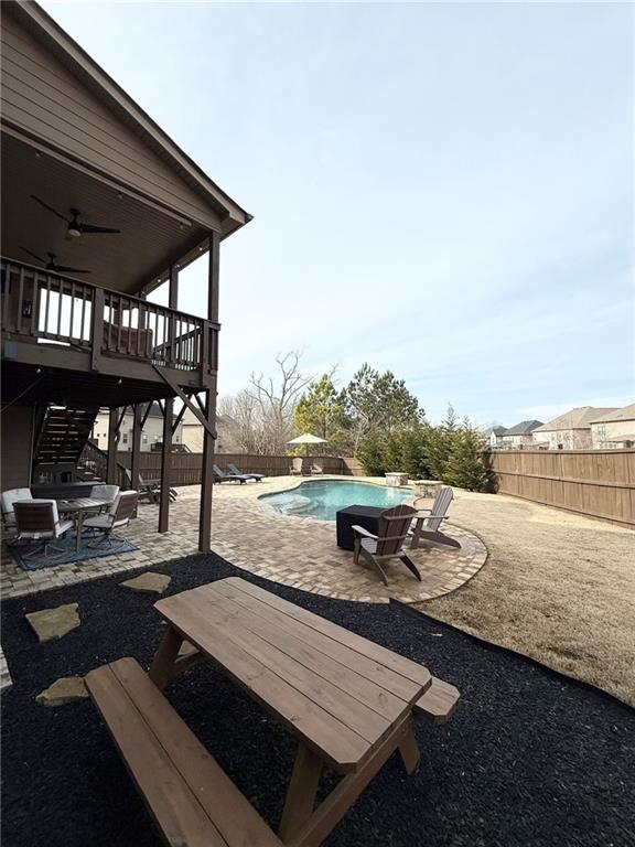 view of patio featuring ceiling fan and a swimming pool side deck