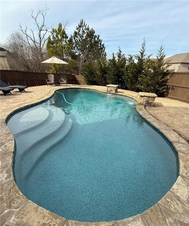 view of pool featuring pool water feature and a patio