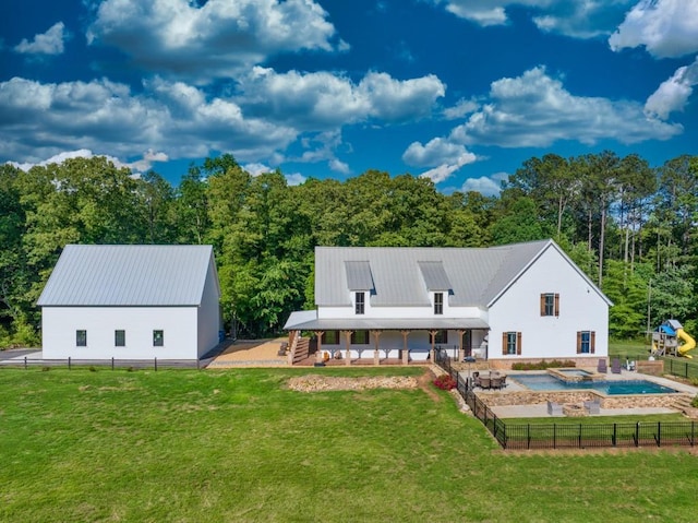 back of house featuring a fenced in pool and a yard