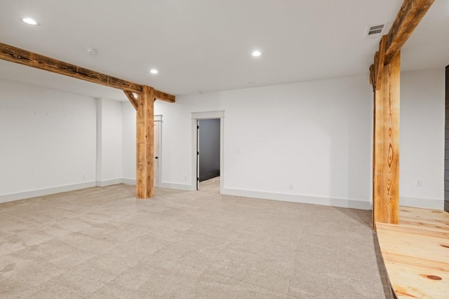 basement featuring light carpet