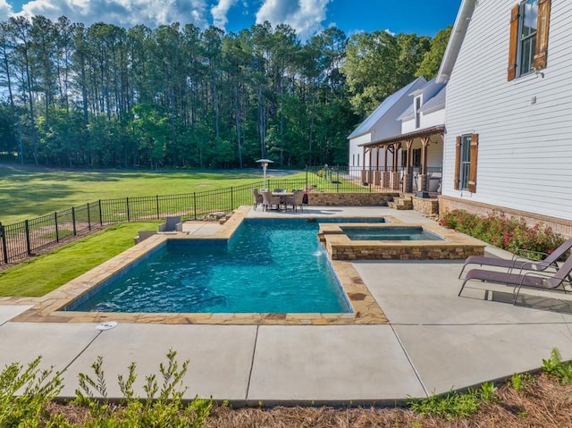 view of swimming pool with an in ground hot tub, a patio area, and a lawn