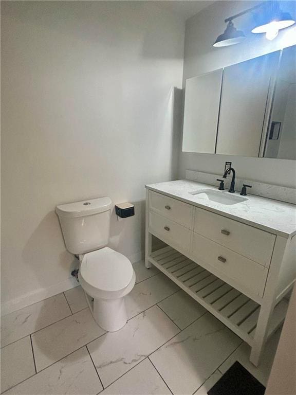 6072 Holiday Blvd, Forest Park, GA 30265 - bathroom with marble look tiles, toilet, vanity, and baseboards