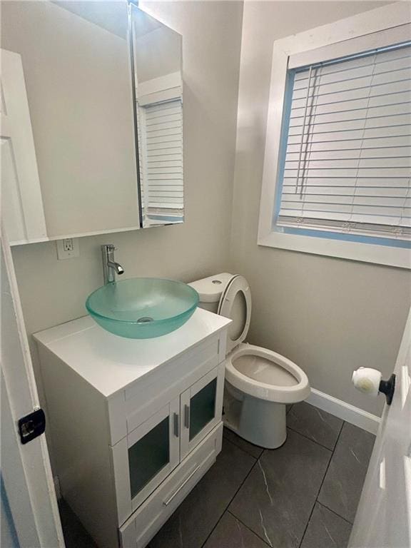 6072 Holiday Blvd, Forest Park, GA 30265 - bathroom featuring vanity, toilet, and tile patterned flooring